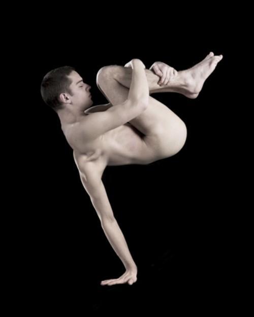 man holding his legs while a morphed arm holds him up